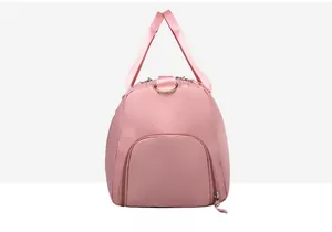 Detailed side view of pink waterproof fitness bag showing separate storage compartment