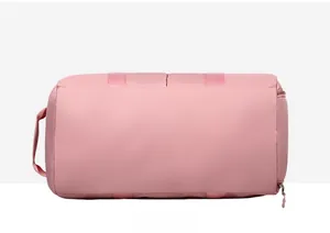 Detail view of the reinforced bottom and sturdy base of a pink waterproof travel duffel bag