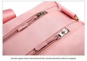 Detail of pink travel bag with durable dual metal zippers and extended non-slip pullers