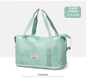 Detail view of the green waterproof travel bag with bottom expansion zipper and logo patch