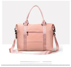 Rear view of pink nylon travel bag showing functional zipper pocket for luggage handles