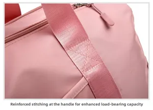Close-up of reinforced cross-stitching on pink travel bag handles for extra durability