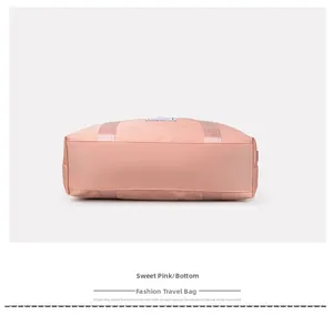Detail view of the wide reinforced bottom base on the pink nylon travel luggage bag