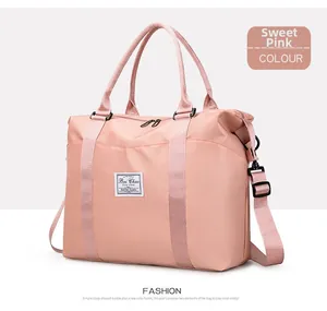 Detail view of pink nylon travel bag with waterproof fabric and adjustable shoulder strap