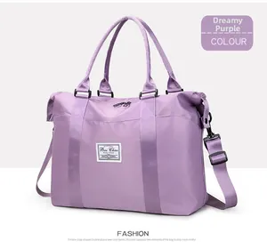 Detail of purple nylon travel bag showing reinforced handles and adjustable black strap
