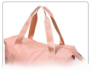 Detail of pink travel bag with reinforced double handles and smooth metal zipper