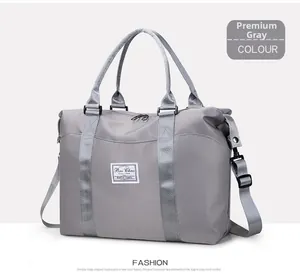 Detail of premium grey nylon travel bag showing durable handles and adjustable shoulder strap