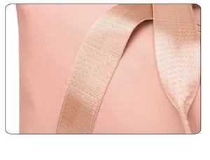 Close-up of reinforced stitching and durable fabric on pink travel fitness bag