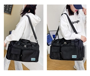Dettagli della borsa fitness in nylon nero con tasche a zip e tracolla regolabile