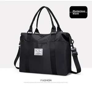 Detail of black waterproof nylon travel bag with detachable strap and sturdy handles