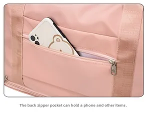 Pink nylon travel bag back view showing a zipper pocket for smartphone storage
