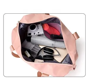 Interior view showing the large capacity of the pink travel bag with various items