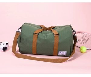 Detail of army green canvas travel bag featuring brown straps and high-capacity structure