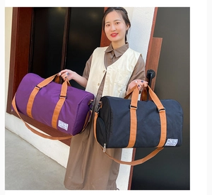 Detail view of water-resistant nylon travel bag with side pockets and sturdy handles