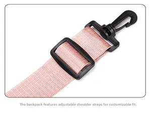 Detail of pink nylon shoulder strap with adjustable black plastic buckle on travel bag