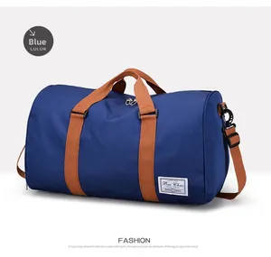 Blue canvas travel bag featuring durable brown straps and metal zipper hardware details