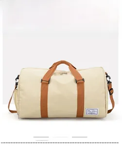 Front view of beige canvas travel bag with brown straps and large main storage space