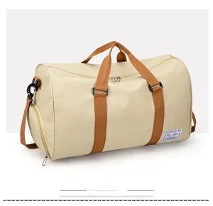 Side view of beige canvas travel bag with brown straps and large compartment