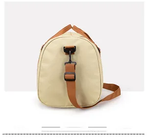 Detail view showing adjustable shoulder strap with durable black plastic hook on canvas travel bag