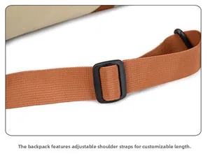 Close-up of adjustable brown woven nylon shoulder strap with a black plastic slider buckle