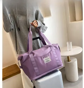 Purple travel bag with luggage strap shown on a silver suitcase handle