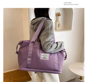 Rear view of a purple water-resistant nylon sports bag with white logo on a model