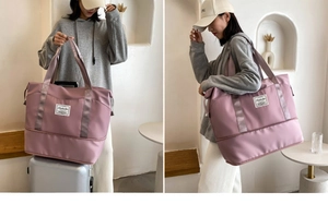 Pink travel bag with back strap for suitcase handles and bottom zipper extension