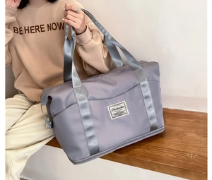 Detail of lavender fitness bag featuring waterproof fabric and reinforced side metal buckle