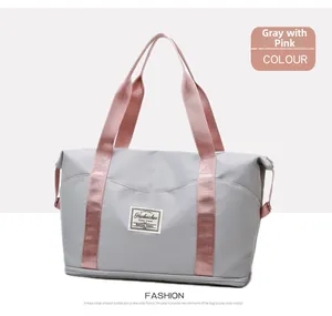 Macro shot of grey nylon fitness bag featuring pink straps and separate bottom wet compartment