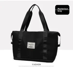 Detail of grey travel bag featuring adjustable side buckles and reinforced handles