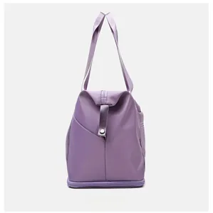 Side view of purple waterproof nylon travel bag with reinforced straps and zipper detail