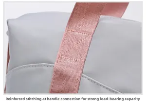 Close-up of reinforced cross-stitching on pink straps for heavy-duty load capacity