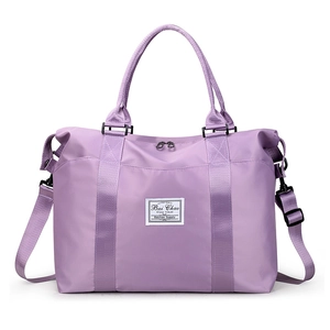 Purple nylon travel duffel bag with water-resistant fabric and adjustable shoulder strap