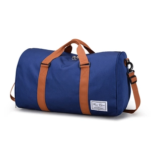 Large navy canvas travel bag with brown handles and waterproof fabric on white background