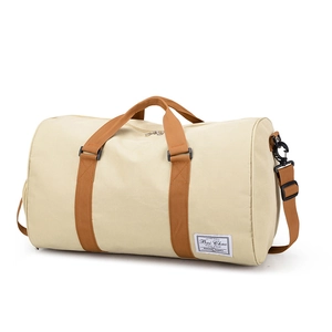 Large beige canvas travel duffel bag with brown straps and spacious interior for gym