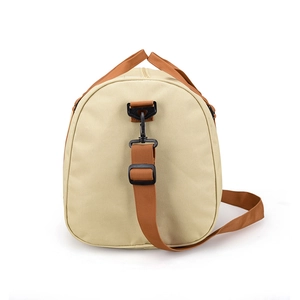 Beige canvas travel bag with brown straps and adjustable shoulder belt on white background