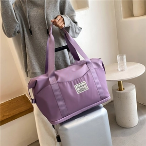 Purple waterproof fitness bag with wet-dry separation on a silver suitcase
