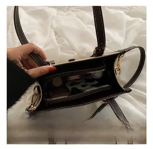 Macro view of leather tote bag interior showing large capacity and white contrast stitching