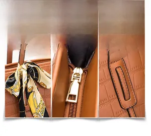 Close-up of brown crocodile texture tote bag with gold zipper and floral silk scarf