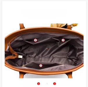 Detail view of tote bag interior with multiple compartments and brown fabric lining