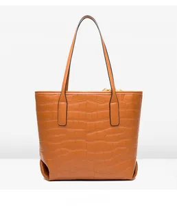 Rear view of brown crocodile-embossed tote bag showing textured PU leather and side detail