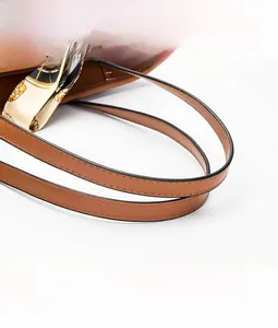 Detail of caramel faux leather tote handle with decorative floral silk scarf accent