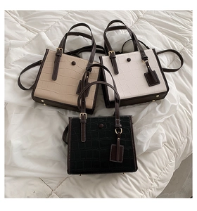 Three crocodile pattern tote bags in beige, white and black colors with metal clasp