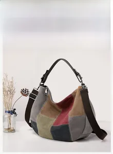 Detailed close-up of multi-color patchwork canvas tote bag with leather handle and strap