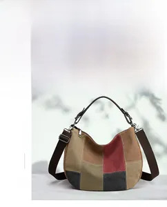 Detail of color-block canvas bag showing retro patchwork and adjustable shoulder strap