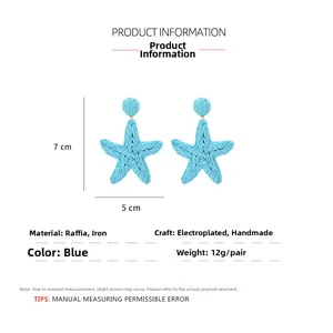 Close-up of blue woven starfish raffia earrings with 7cm x 5cm size and 12g weight details