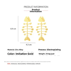 Detailed view of oversized gold fishbone earrings with exact size and weight dimensions