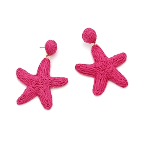 Detailed view of hand-woven hot pink raffia starfish earrings with circular stud