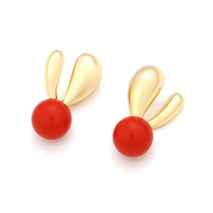 Close-up of red candy-colored resin drop earrings with golden heart-shaped accents