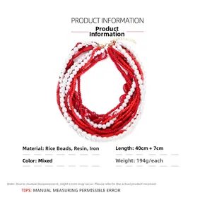 Detailed view of layered red and white baroque bead necklace with metallic clasp